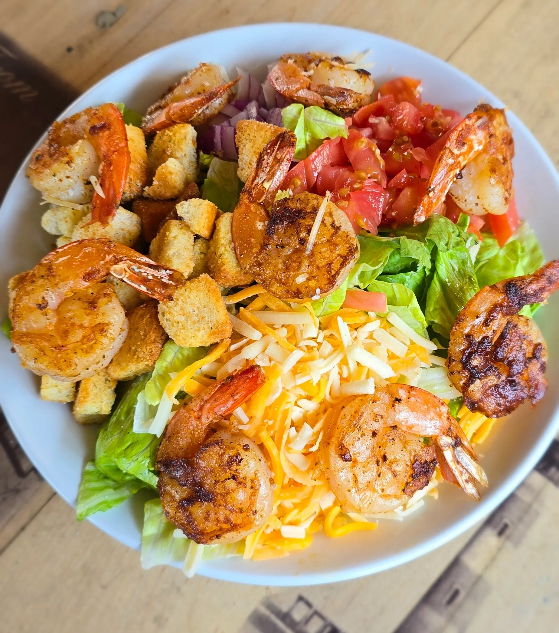 House salad topped with seasoned grilled shrimp, shredded cheddar and Monterey jack, croutons, diced tomato, and red onion.